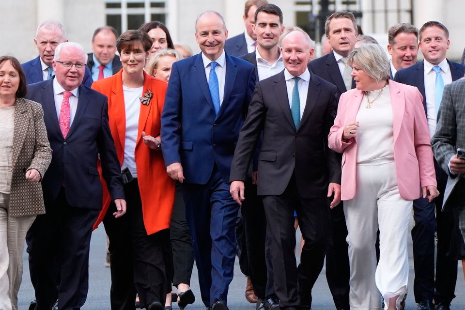 Taoiseach Micheal Martin (centre left) with former Dublin Gaelic football manager Jim Gavin, who has been announced as the Fianna Fail presidential candidate, at Leinster House in Dublin. Photo: PA